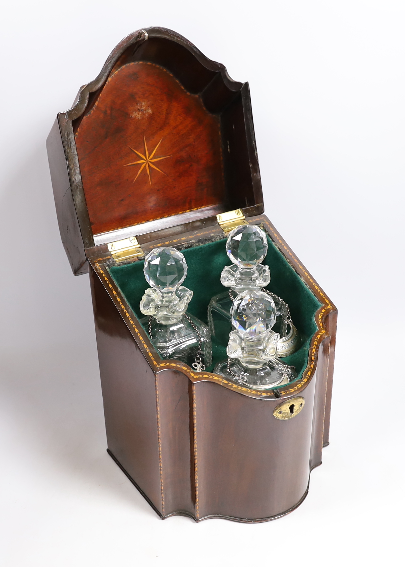 A tantalus with three decanters and three George III silver crescent shaped wine labels, Nathaniel Smith & Co, Sheffield, circa 1790.